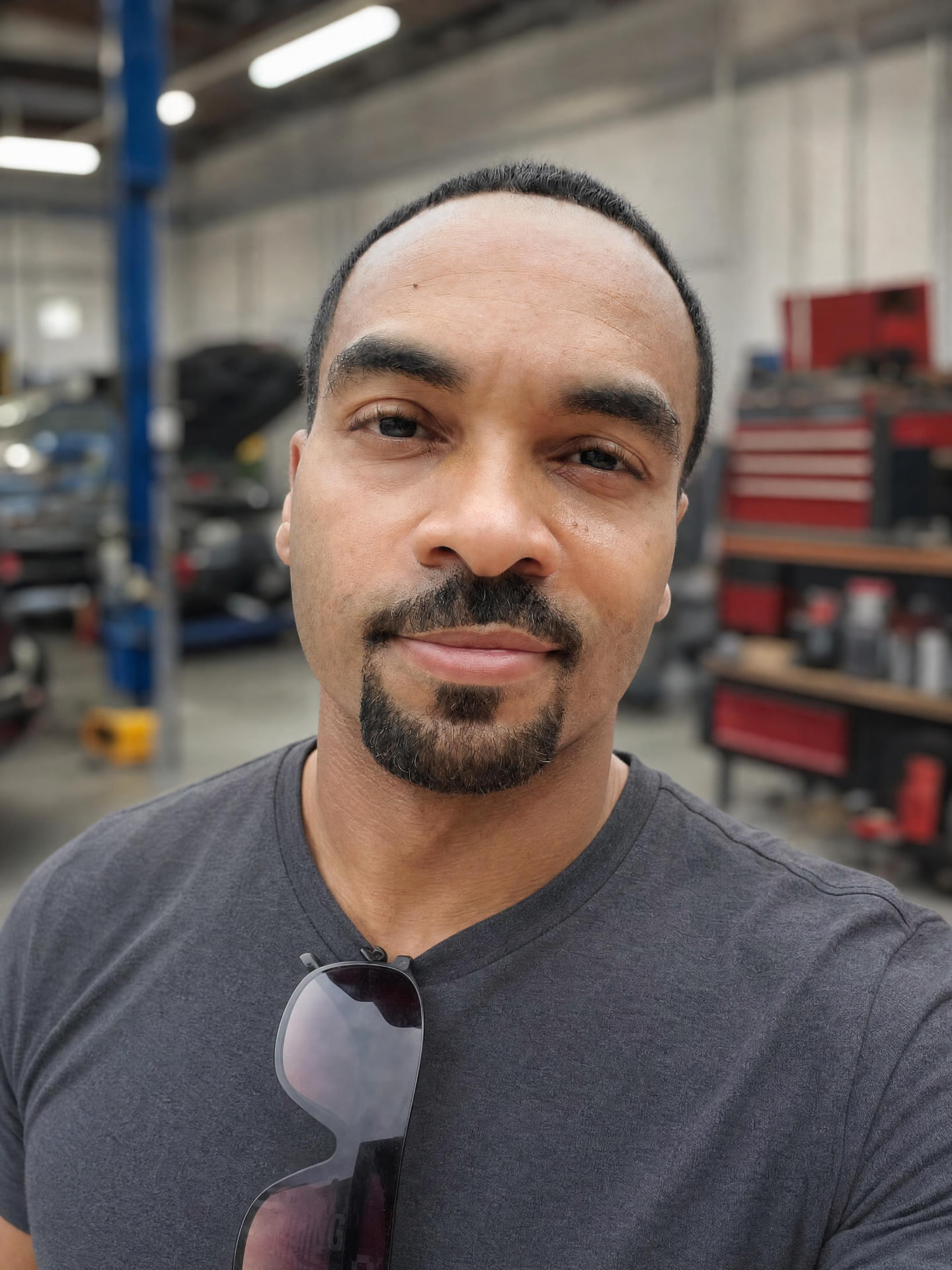 Skylar, founder of Relentless Reviews, in an auto repair shop